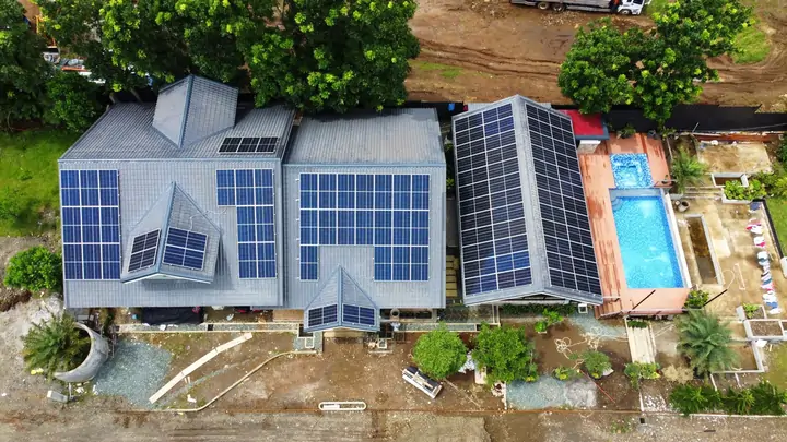 A modern home with solar panels installed on the roof.